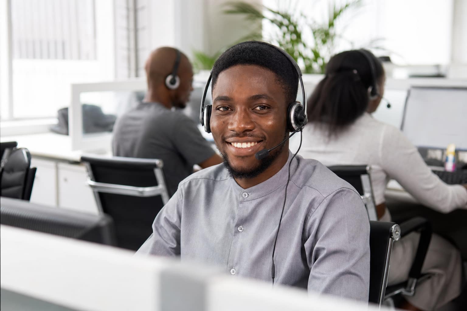 Quality calls, real confirmation results — GoodGoods GoodGoods Nigerian male call center agent wearing a headset in a bright office